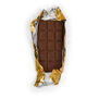 A milk chocolate bar wrapped in a gold foil and paper.